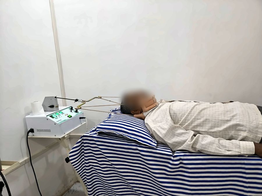 Patient receiving mechanical cervical traction with a head halter for neck pain at MuvAgain Physiotherapy Patna