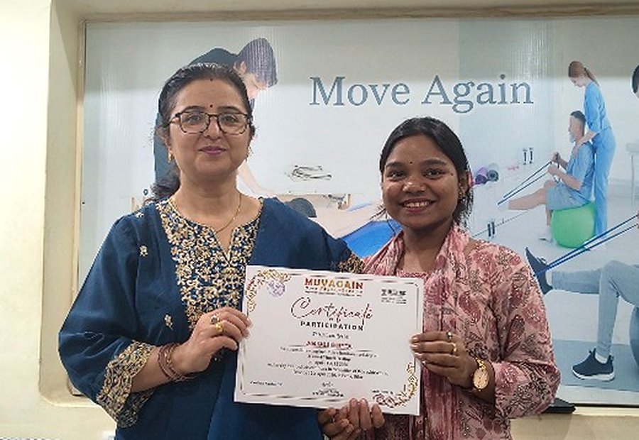 Dr Josni Pandey with Dr. Anjali Gupta (PT) holding a MuvAgain certificate at the clinic